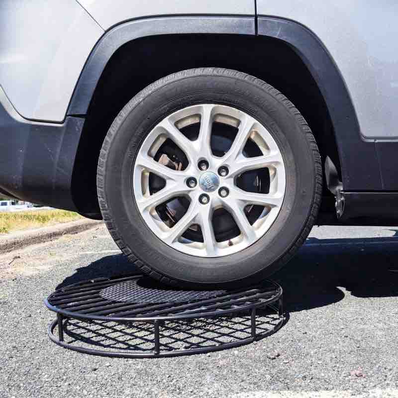 Car driving over original fire pit grate.