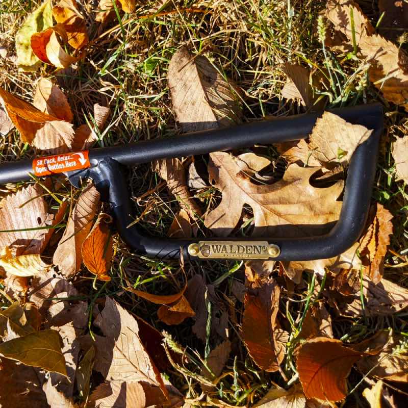 Close up of handle of Walden fire poker with golden medallion logo