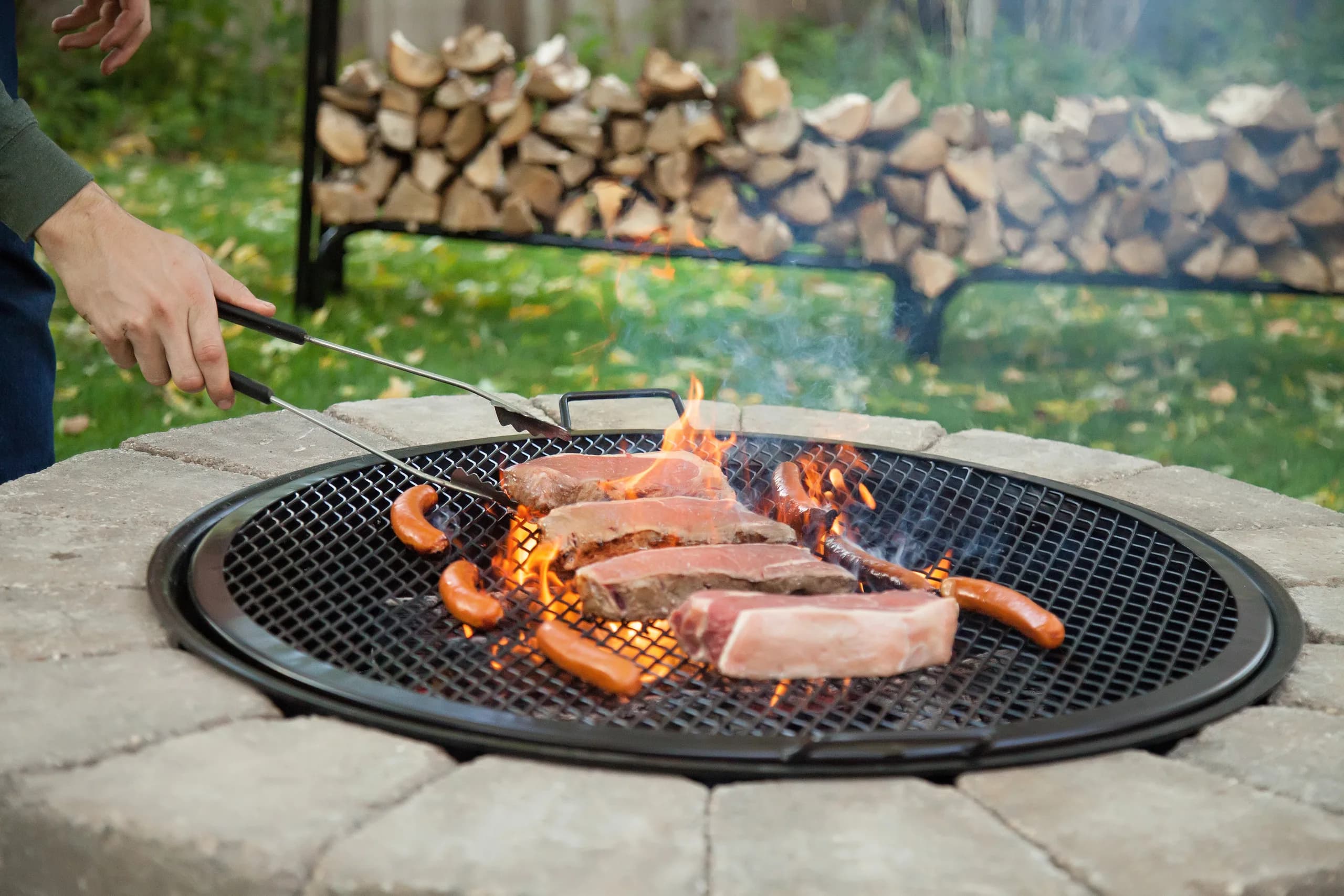 Steel grate with even spacing sitting above a fire pit, ready to cook
