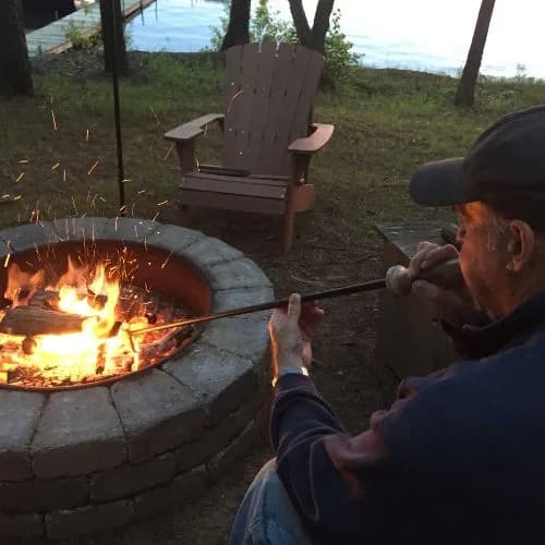 A quiet evening fire by the lake, a Stoker Poker resting against the pit