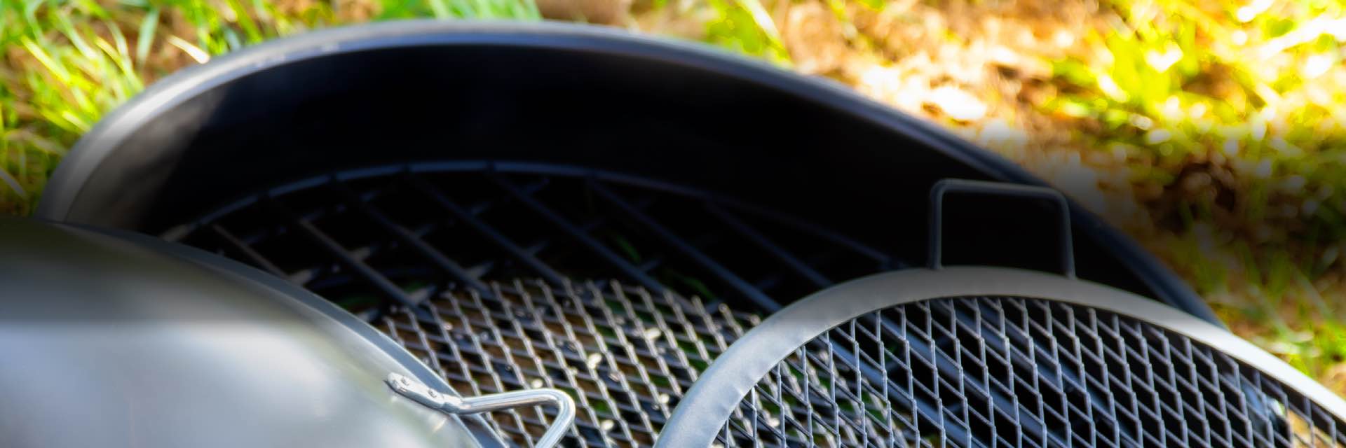 Fire pit grate and BBQ grilling grate inside a fire ring and a firepit cover