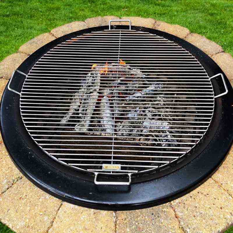 Create  a grill over your fire pit by placing the round stainless steel grate over the fire.