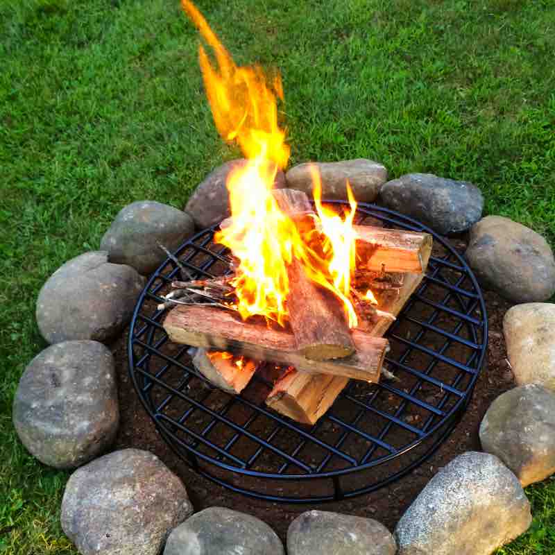 Stacked Firewood burning over tall original steel fire pit grate providing optimal airflow.