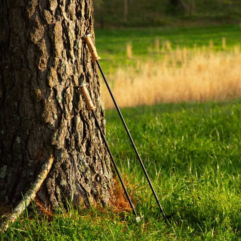 Two sizes of Walden blow through stoker pokers leaning against tree