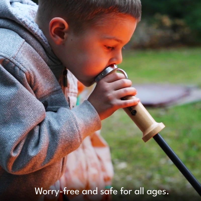 Boy losing into mouthpiece of Walden blow through stoker poker