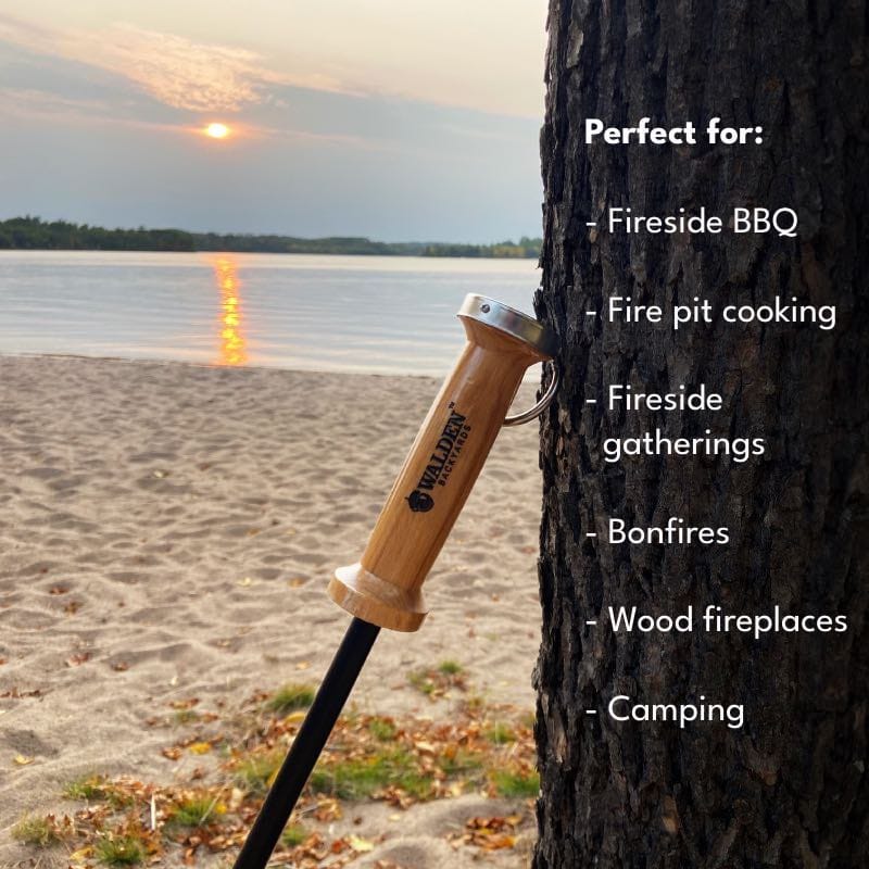 Walden blow through stoker poker on beach leaning against a tree