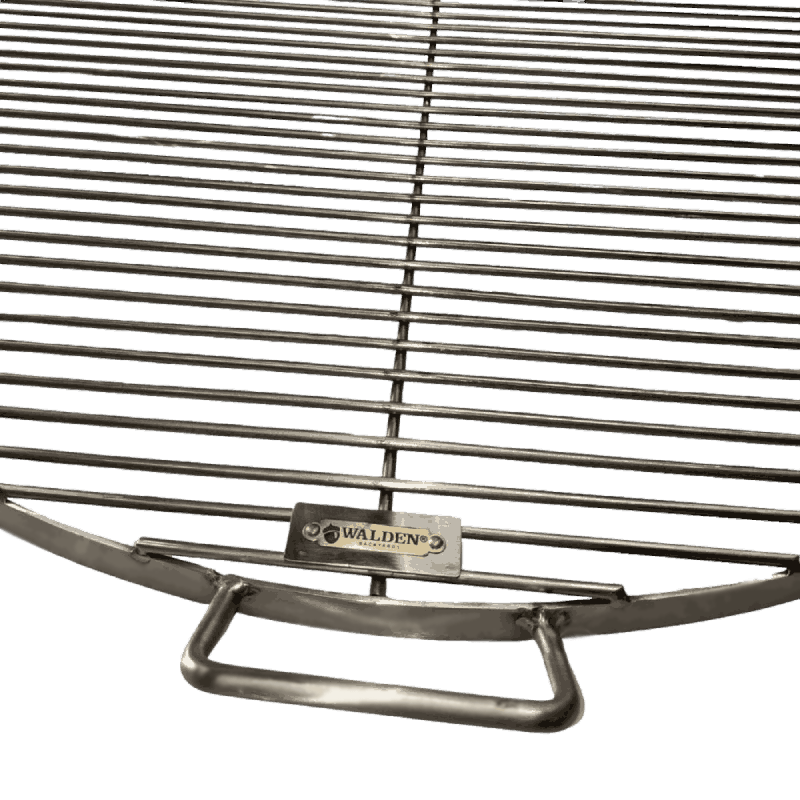 Close-up of beefy handle welded onto side of stainless steel grate.